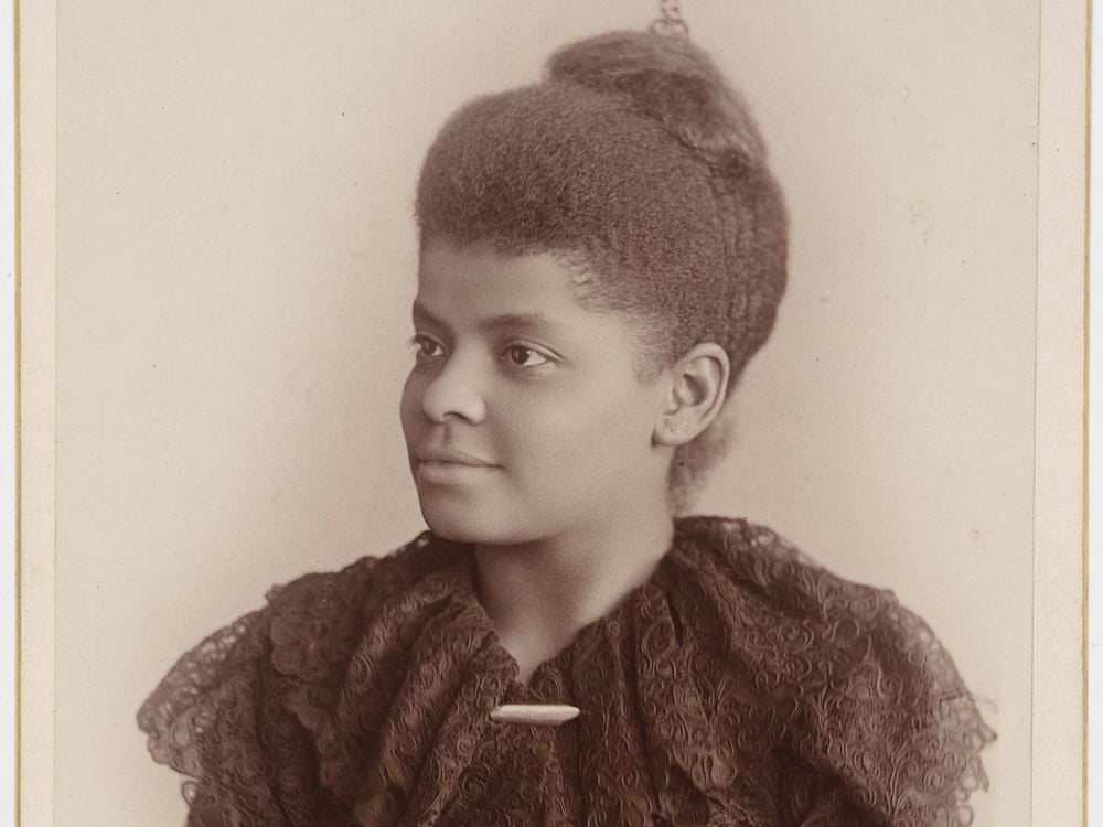 Portrait of Ida B. Wells from the waist up in 3/4th profile.