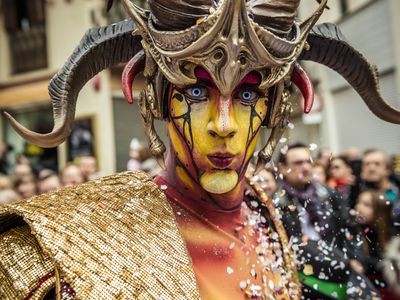Fictitious Catalan figures known as "carnestoltes" dance in the street during the Carnival parade in Sitges, Spain.