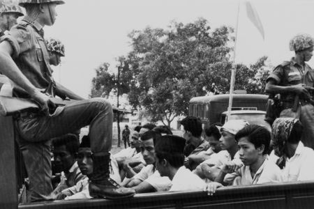 In this Oct. 30, 1965, Associated Press file photo, members of the Youth Wing of the Indonesian Communist Party (Pemuda Rakjat) are watched by soldiers as they are taken to prison in Jakarta.