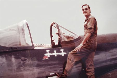 Fernando Soto in 1970 atop his Honduran Corsair, with symbols marking his victories. The aircraft is now in the Honduras air museum, which keeps it in running (but not flying) condition.