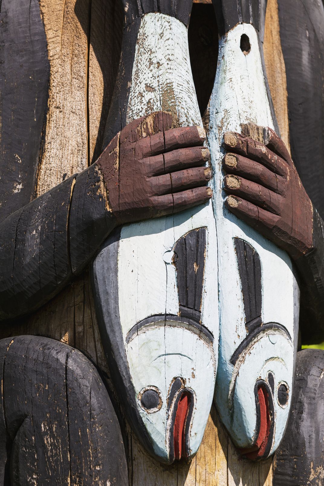 detail of salmon on totem pole