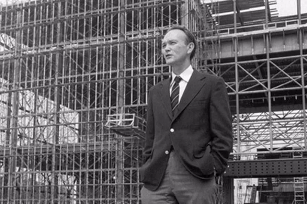 Michael Collins stands in front of the steel skeleton of the new National Air and Space Museum in July 1974