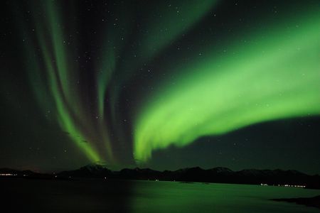 Northern lights ignite the sky.