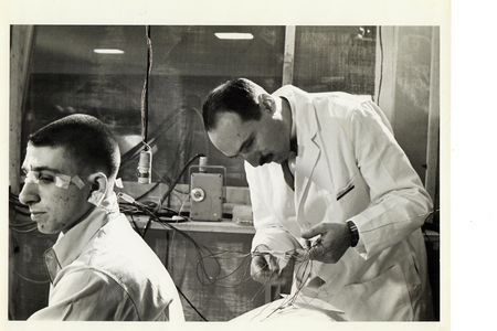 Neuroscientist Eugene Aserinsky attaches electrodes to his son, Armond, who was a frequent subject in his early sleep studies