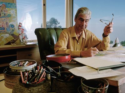 Dr. Seuss drawing at his desk