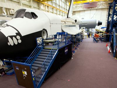 NASA astronaut Rex Walheim walks past the Full Fuselage Trainer (FFT) as the crew of STS-135 trains in the Space Vehicle Mockup Facility (SVMF) at the Johnson Space Center  on Wednesday, June 29, 2011, in Houston. The training marked the crew's final scheduled session in JSC Building 9, or SVMF. ( NASA Photo / Houston Chronicle, Smiley N. Pool )