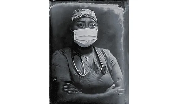 Navajo woman , Sophina Calderon, wearing a mask and stethoscope