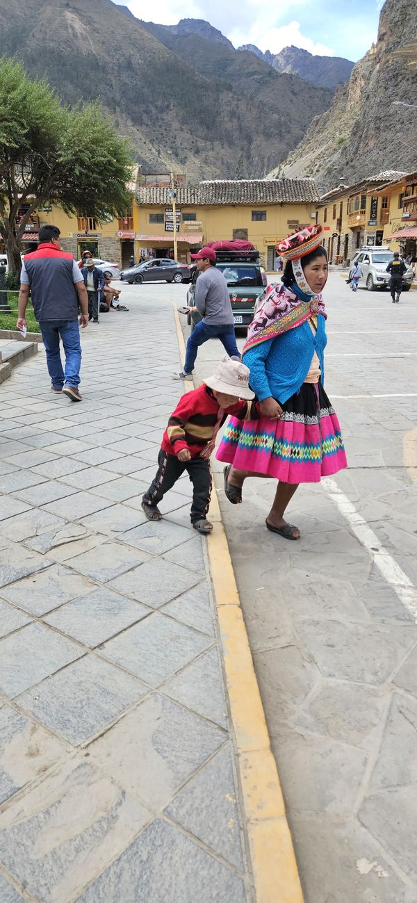 Mother and son hurry across the street in Peru. thumbnail