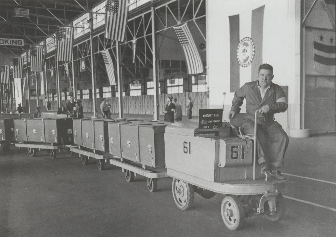 A battery-powered tractor moves war remains on Pier 3 at the Brooklyn Army Terminal.