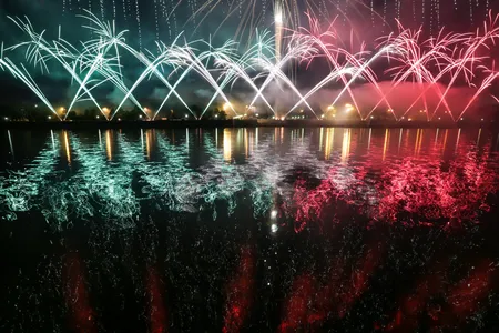 Fireworks go off over the Moskva River.