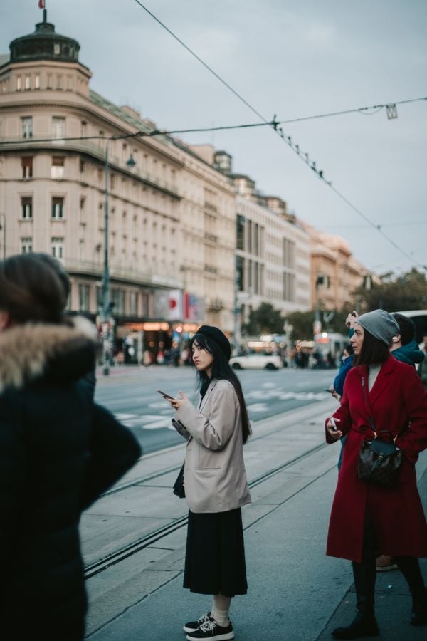 An Asian girl waiting for a transport in Vienna thumbnail