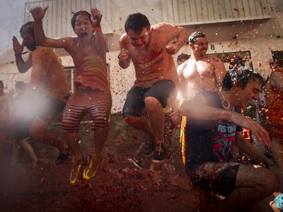 Revelers are splattered with tomatoes during the yearly La Tomatina festival in Bunol, Spain.