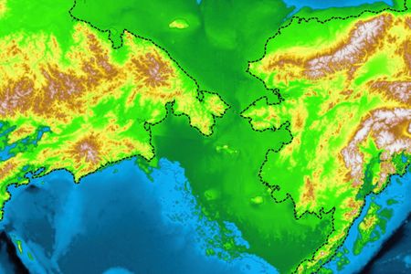 Russia and Alaska's current coastlines (the dashed black lines), compared to ancient Beringia (shown in green), the land bridge that brought humans to North America.