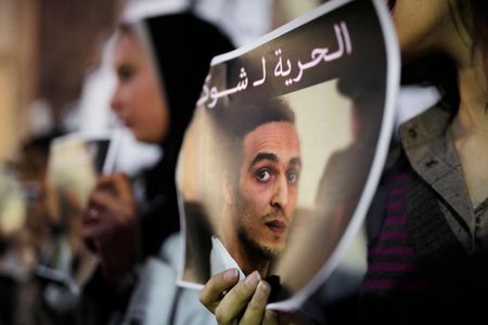 Egyptian journalists hold posters calling for the release from prison detention of Mahmoud Abou Zeid, in front of the Syndicate of Journalists building in Cairo, Egypt, on December 9, 2015.