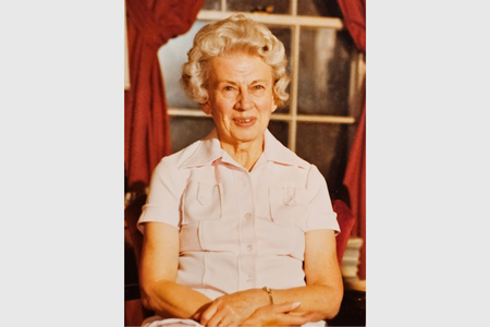 Rebecca Northen seated with her hands crossed in her lap facing the camera.