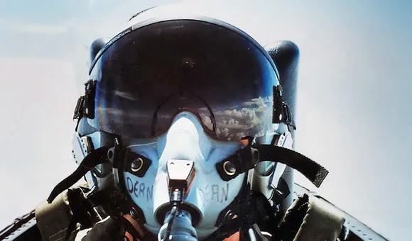 Selfie of Joy Dean in her flight helmet. Clouds are reflected in the visor.
