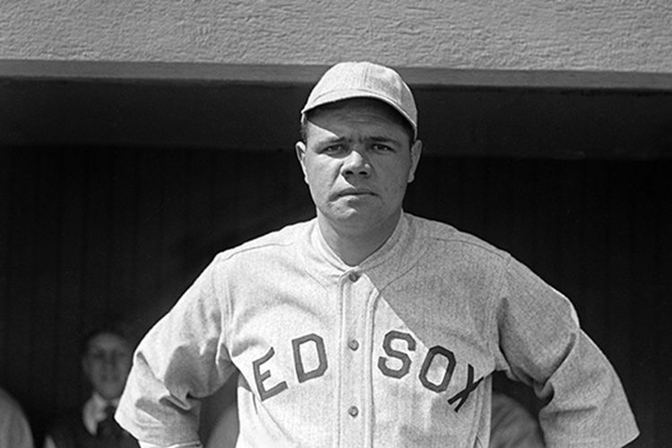 Babe Ruth, wearing a Red Sox uniform, looks squarely at the camera