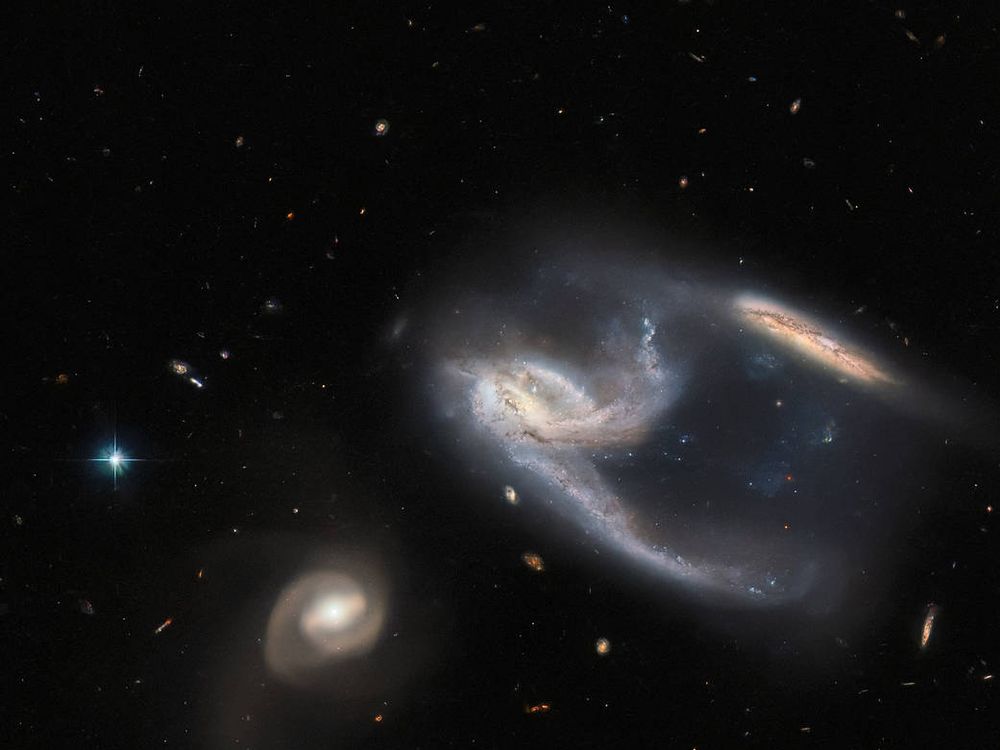 An image of three swirling galaxies taken by the Hubble Space Telescope