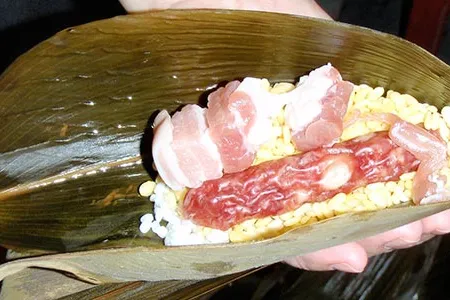 Zongzi, also known as jung, contains rice, beans, sausage, pork and bamboo leaves.
