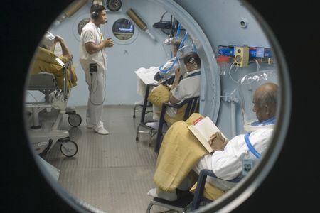 SSgt Jalkenne Joseph, Aerospace Medical Craftsman from the 959th MSGS, Wilford Hall, monitors patients in the USAFSAM Clinical Hyperbaric Medicine, hyperbaric pressure chamber. By spending time in the chamber patients are exposed to excessive amounts of oxygen which enriches the blood to the point where oxygen is even carried by plasma, which increases the body�s ability to heal. (US Air Force photo by Steve Thurow)
