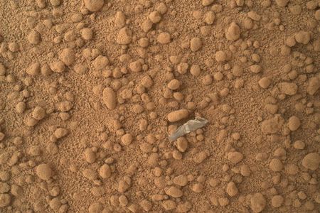 The first shiny object found on Mars, thought to be plastic shed from Curiosity.