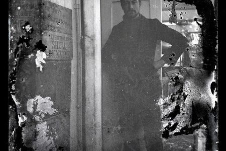 The Shackleton expedition's scientist, Alexander Stevens, stands on one of the team's ships, the Aurora.