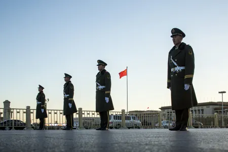 Military police during the ceremonial lowering of the Chinese flag in Tiananmen Square.