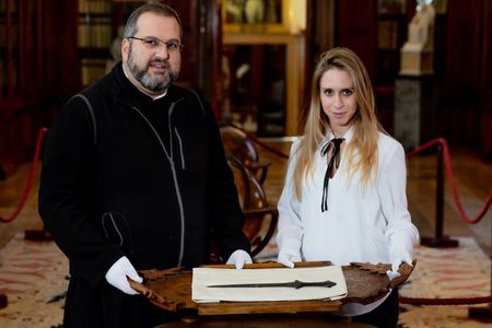 Serafino Jamourlian of the monastery of San Lazzaro degli Armeni and Vittoria Dall'Armellina with a newly rediscovered 5,000-year-old sword