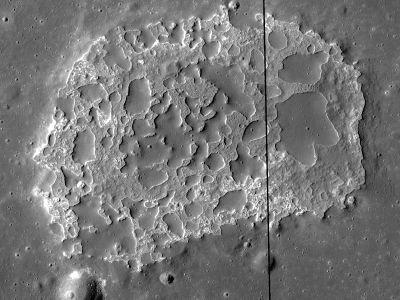 Ina, an unusual depression about 3 km across near the center of the near side of the Moon. The smooth areas appear to lie on top of the rough surface; analysis of this feature suggests an age of about 30 million years, astonishingly young in lunar terms.
