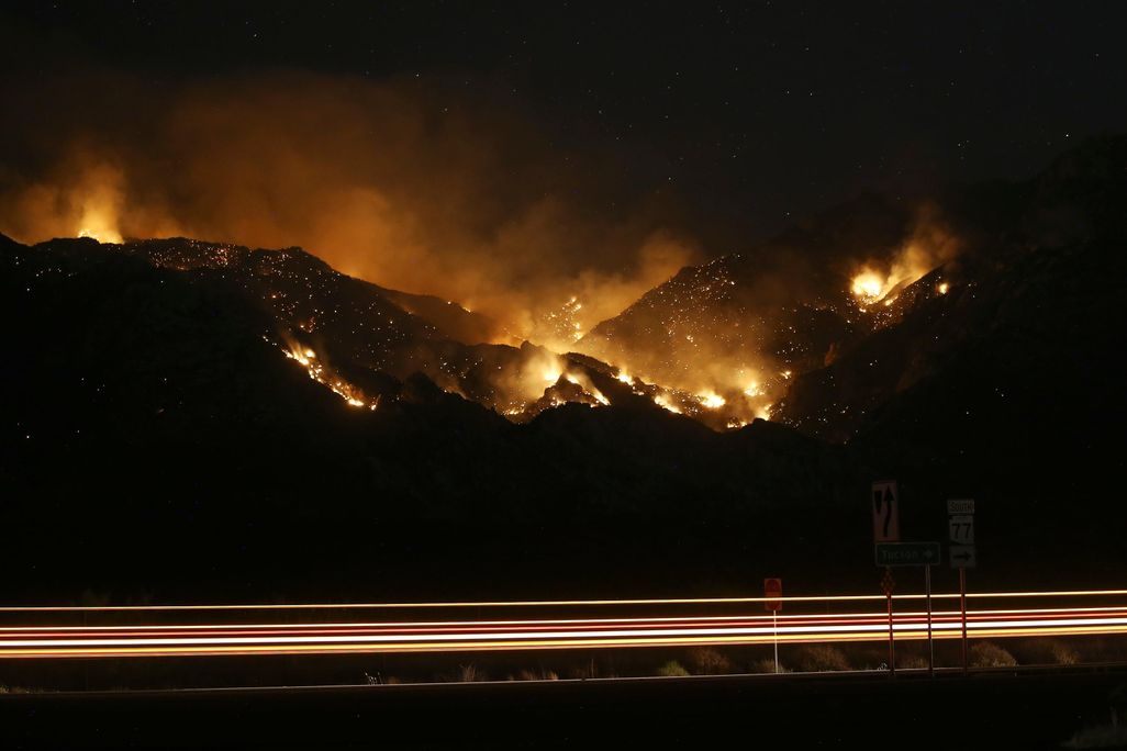 The Bighorn Fire burns through the western side of the Santa Catalina Mountains in Oro Valley, Arizona