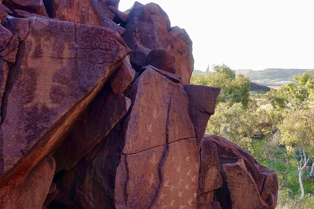 Reddish-colored rocks with figures and symbols on them