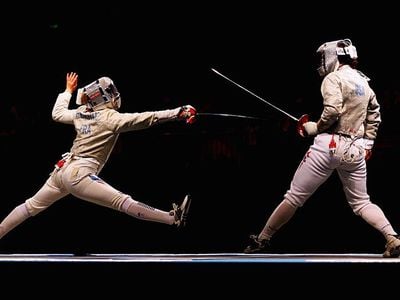 Sada Jacobson Baby (right) of the United States battles with Leonore Perrus of France in the bronze medal match in the Women's Team Sabre event at the 2008 Olympic Games in Beijing.