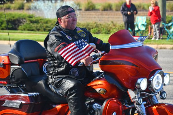 A veteran motorcyclist, with many others, kickoff the Veterans Day Parade 2023. thumbnail