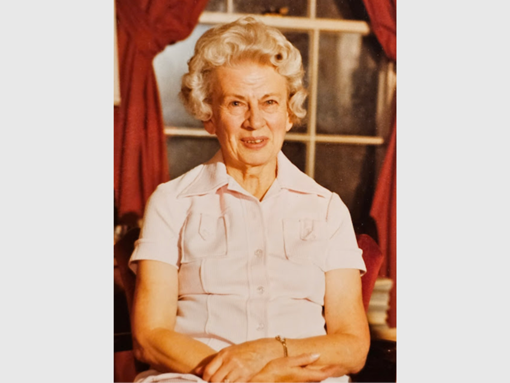 Rebecca Northen seated with her hands crossed in her lap facing the camera.