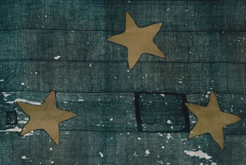 Three cotton stars on blue canvas background