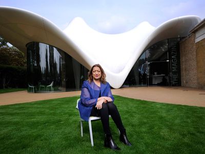 The late Zaha Hadid sits in front of one of her structures, the Serpentine Sackler Gallery in London.