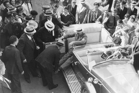 President Franklin D. Roosevelt exits a car during a campaign stop in California. Roosevelt was the first U.S. president with a visible disability, caused by polio.