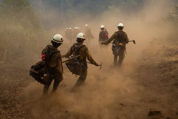 Wildland firefighters hiking though dust thumbnail