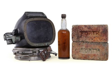 A bottle of whiskey, a diving helmet and bricks recovered from the wreck of the SS Politician, which sank off the coast of Scotland in 1941.