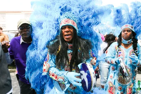 Big Chief Monk Boudreaux (center) leads his Mardi Gras Indian tribe, the Golden Eagles, on Super Sunday.