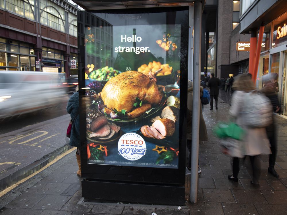 A bus shelter in London with an advertisement for a Tesco Christmas turkey on it