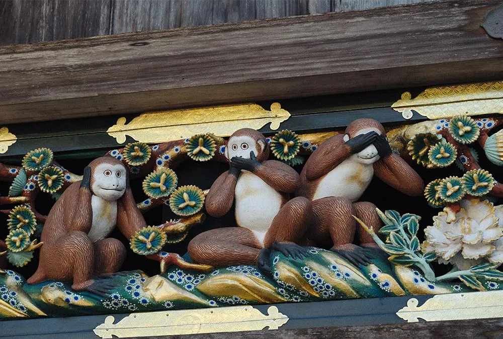 A carving of the Three Wise Monkeys on the sacred stable at the Nikko Toshogu Shrine complex