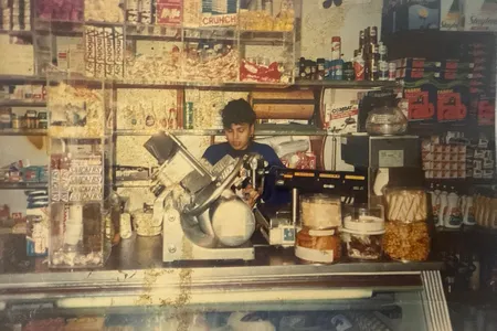 A vintage image of author Amaris Castillo's mother, Damaris, working at a bodega