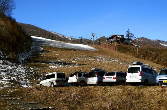 A chairlift hangs limp over a Japanese ski slope almost void of snow in December 2006.