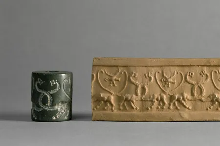 A cylinder seal (left) engraved with symbols that was used to press markings into wet clay (right)