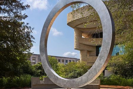 The National Native American Veterans Memorial, designed by Cheyenne and Arapaho artist Harvey Pratt, features a steel circle balanced on a carved drum.
