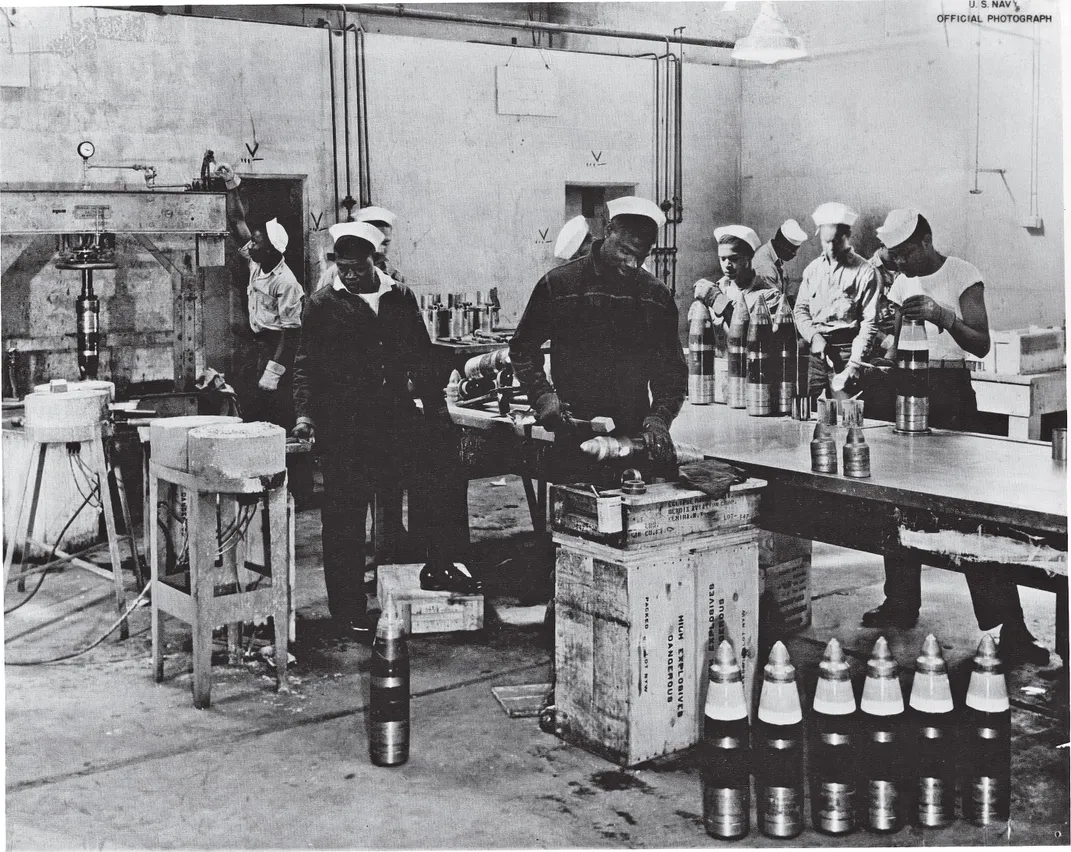 Navy sailors in an ammunitions room
