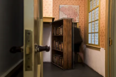 A woman enters the secret annex at the Anne Frank House Museum in Amsterdam. The new exhibition in New York will be the first full-scale replica.