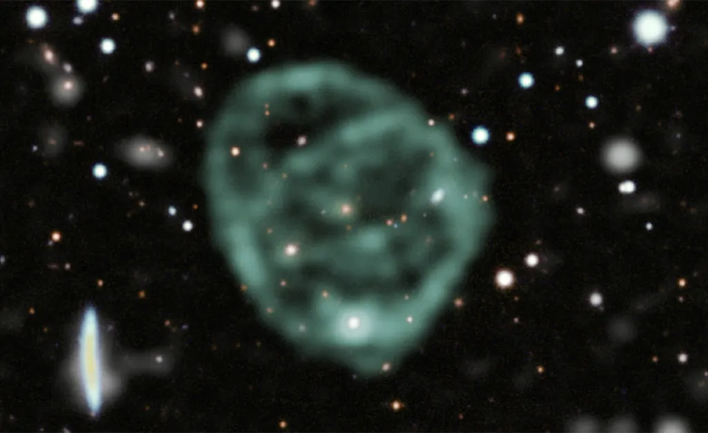 A blurry light-green circle surrounded by stars in space