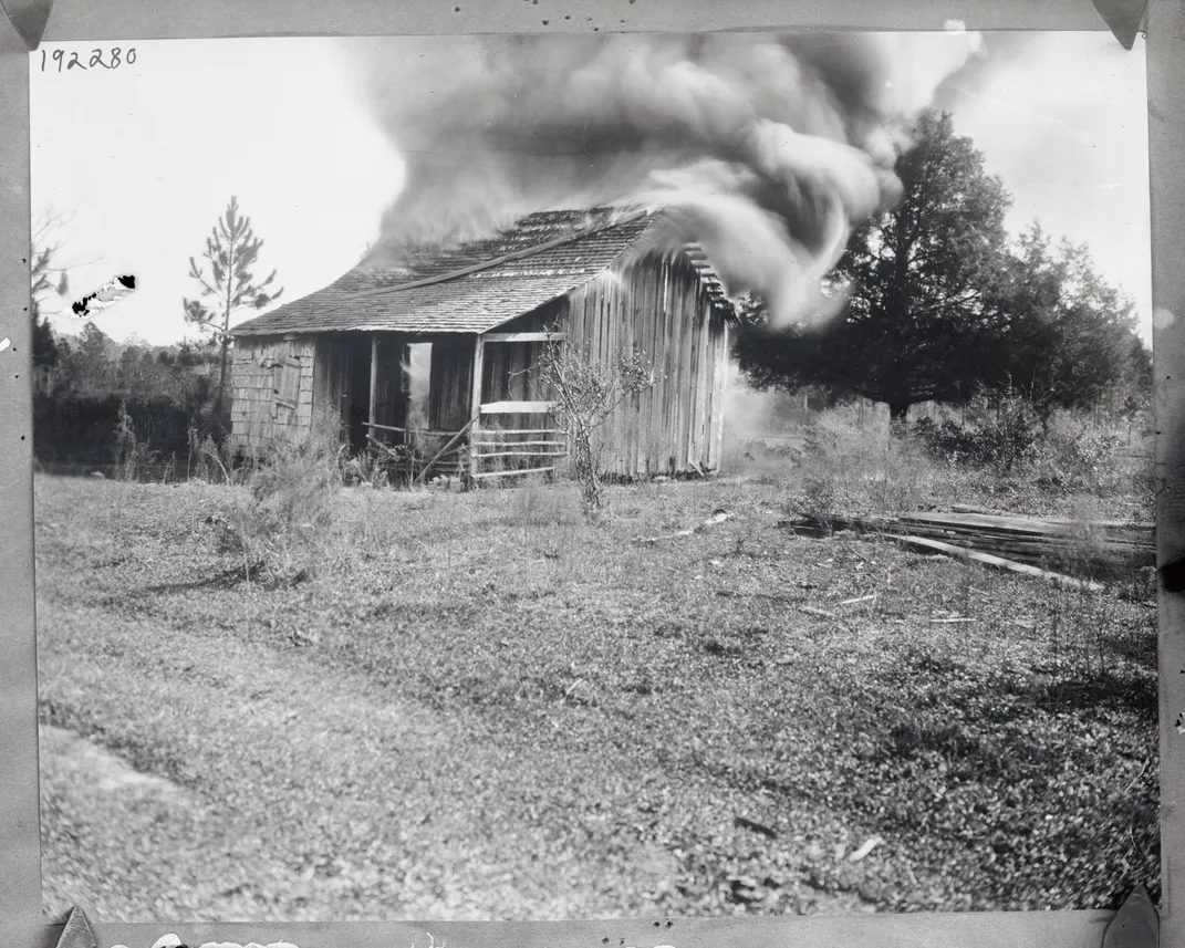 View of a house on fire in Rosewood, Florida, in January 1923
